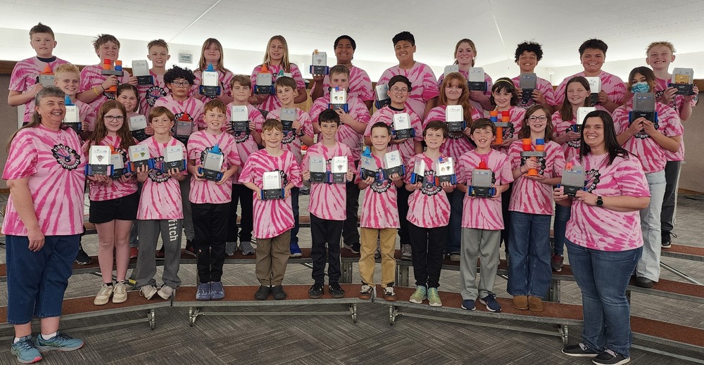 Robotics club posing with their trophies