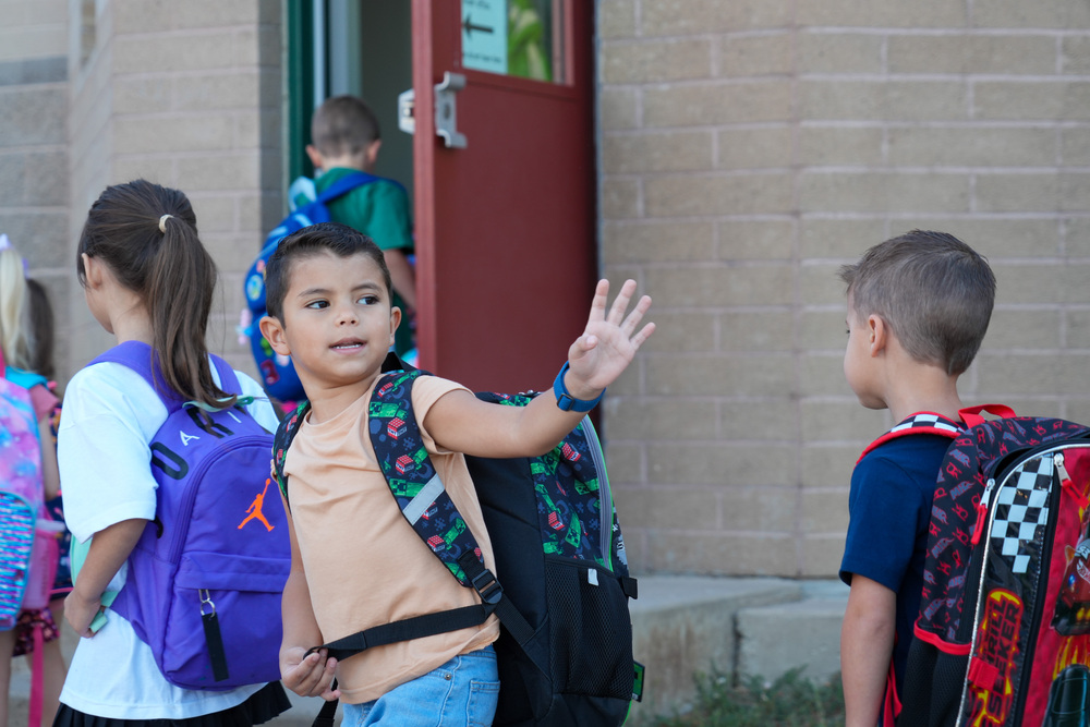 Little Boy waving goodbye