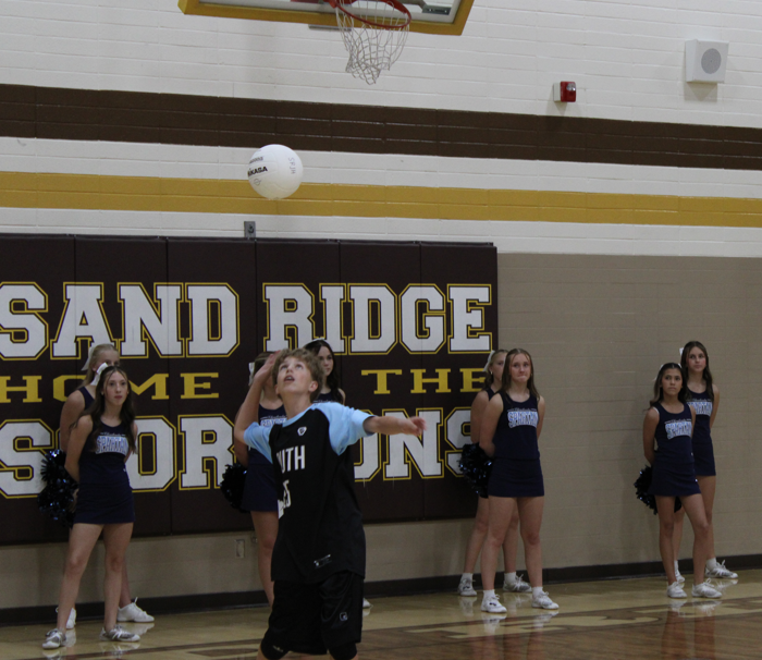 Student Andrew Robertson Serving A Volleyball