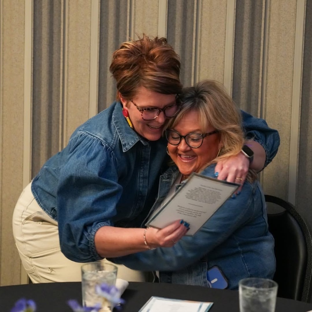 Picture of Becci hugging previous plain city elementary staff Cami Argyle