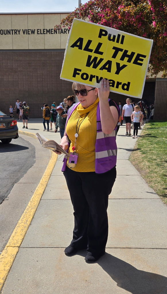 Teacher holding sign while reading