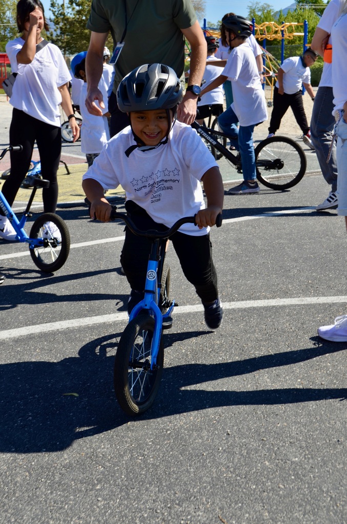 boy riding a balance bike