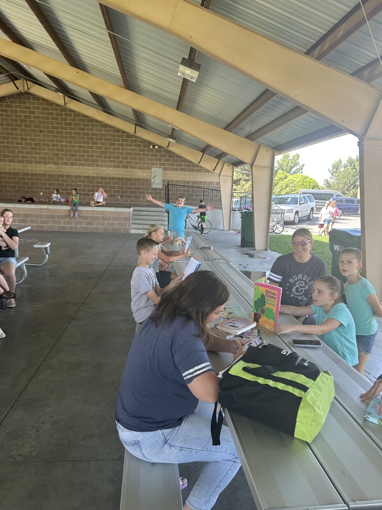 Pioneer students reading at the park.