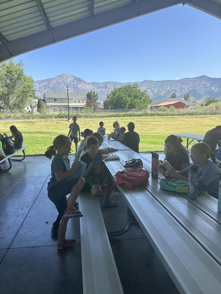 Pioneer students reading at the park.