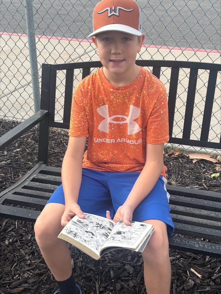One boy reading on a bench. 