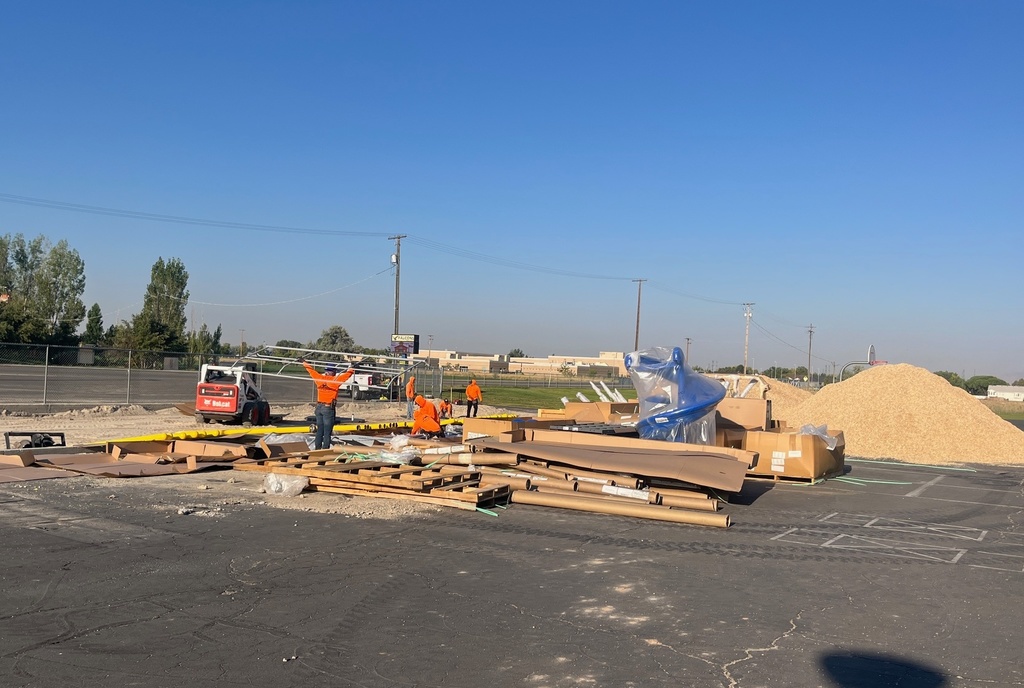 Boxes and workers installing playground
