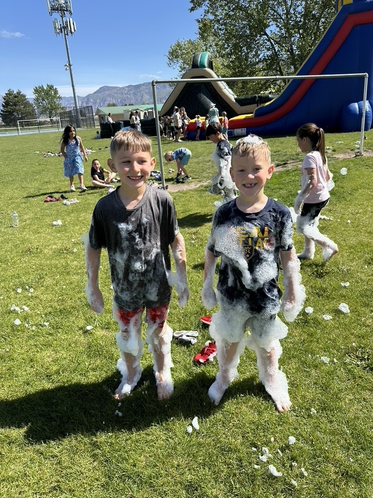 students covered in bubbles from the foam pit at field day