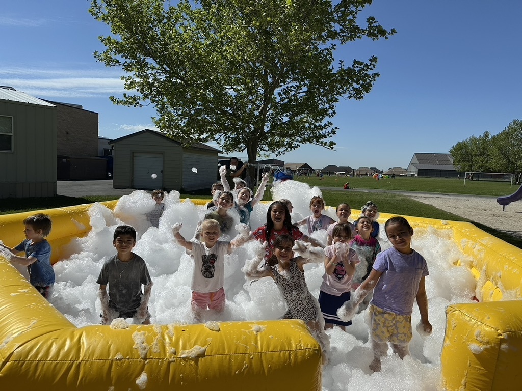 first grade students in a bubble pit