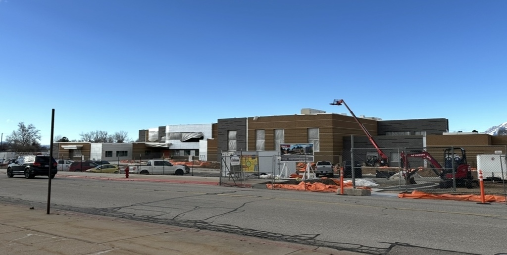 the process of the roosevelt rebuild- there is brick on the building now- a crane is loading things onto the roof