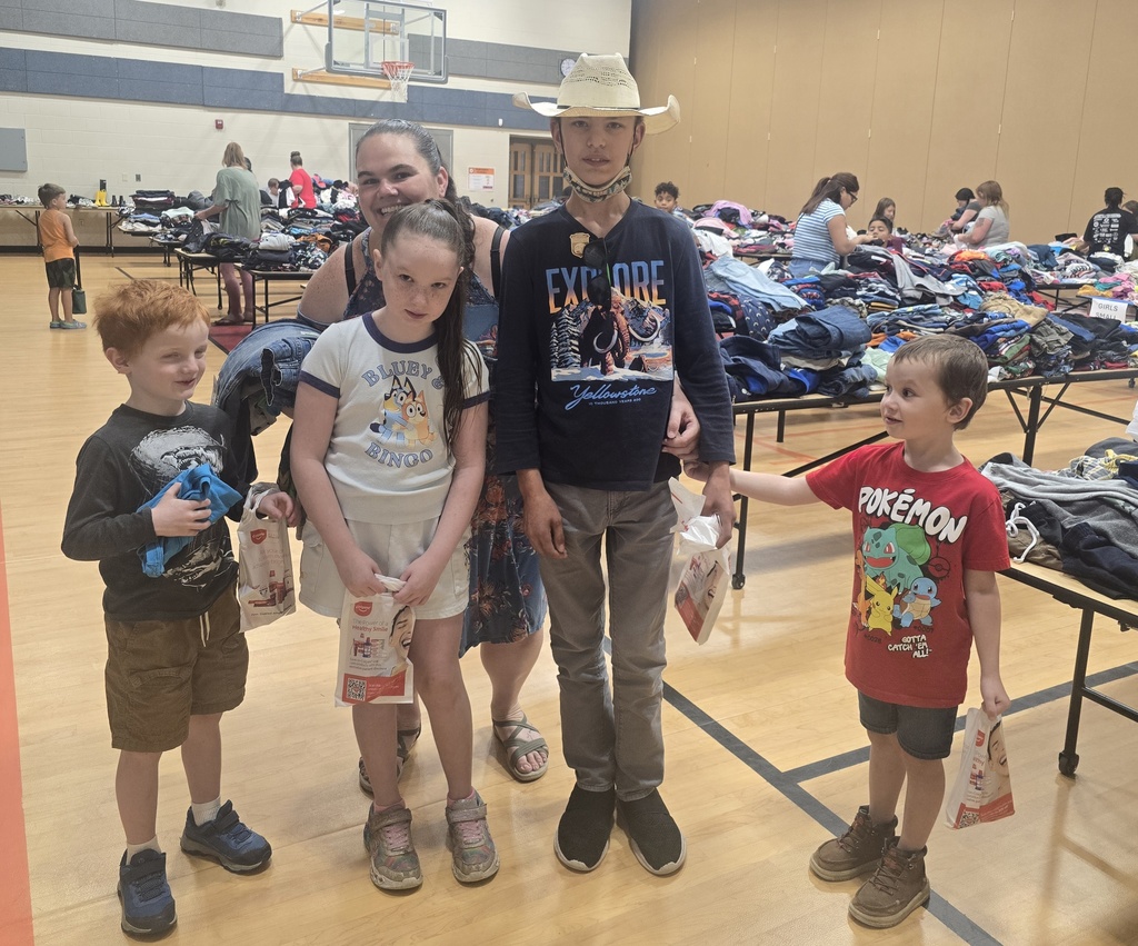 A mother, her three boys, and daughter at the clothing event.