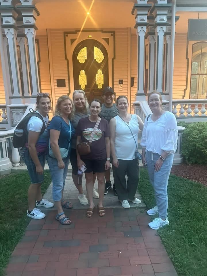 Teachers standing in front of an old house in Raleigh North Carolina