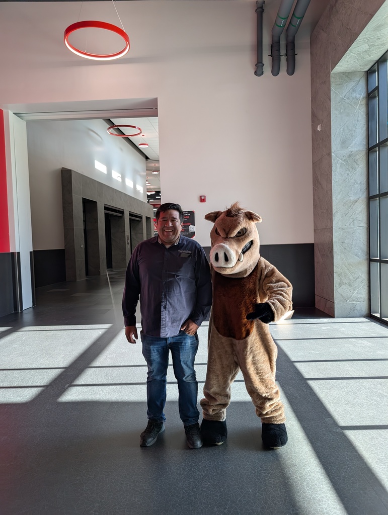 Photo of our Mascot Raz  with our custodian, showing the clean hallways