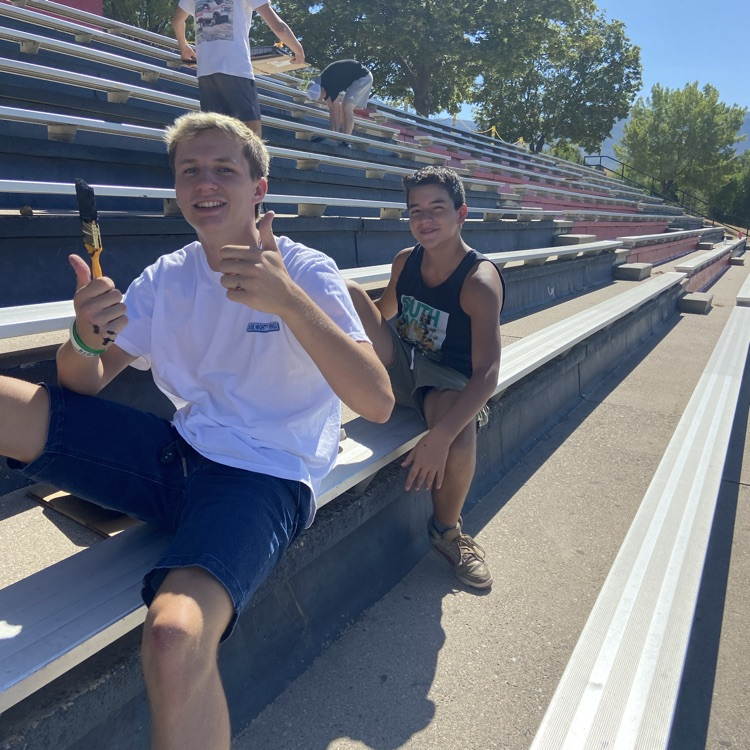 students painting the stadium 