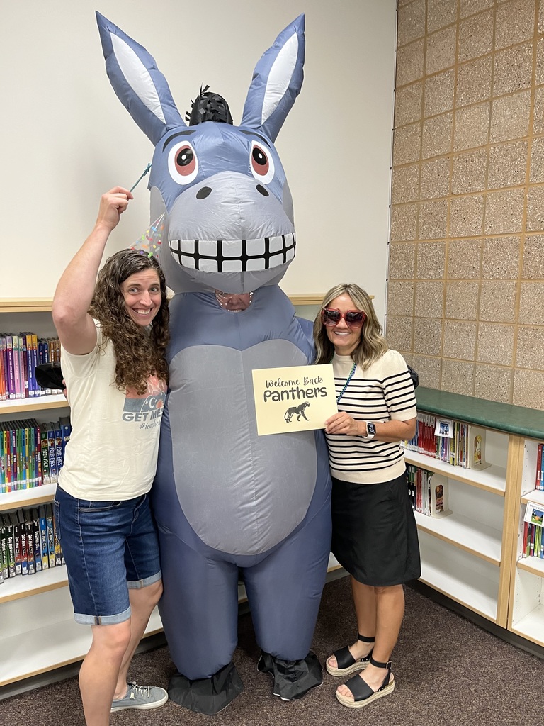 Picture of Mrs. Wiser making a fun face and holding a wand, Miss G in a donkey costume, and Mrs. Elliott holding a sign that says "welcome back panthers" and she is wearing funny sunglasses.