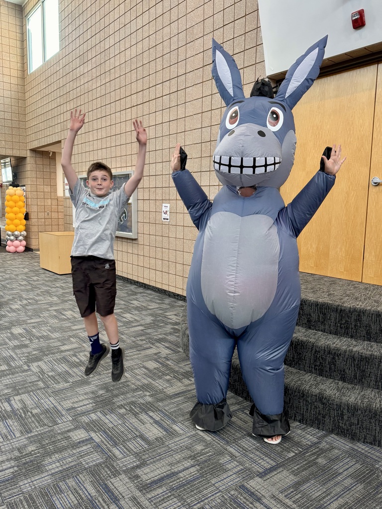 Student jumping with Miss G in a donkey suit