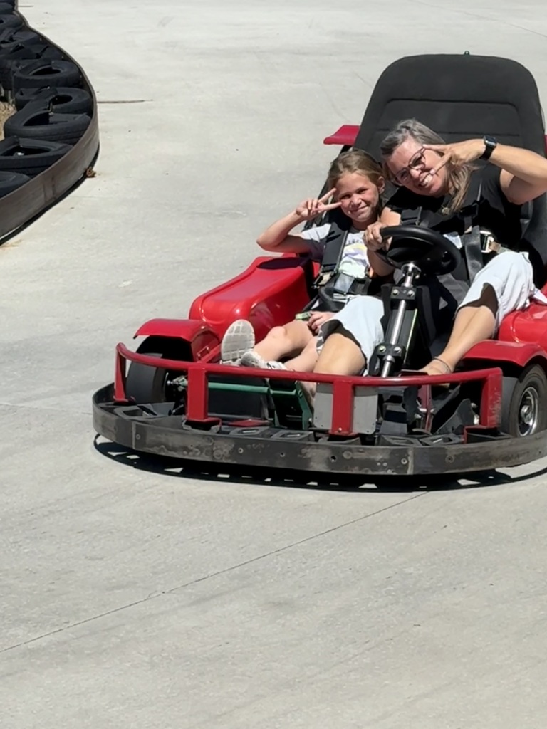 Mrs. Gines and daughter on a go cart