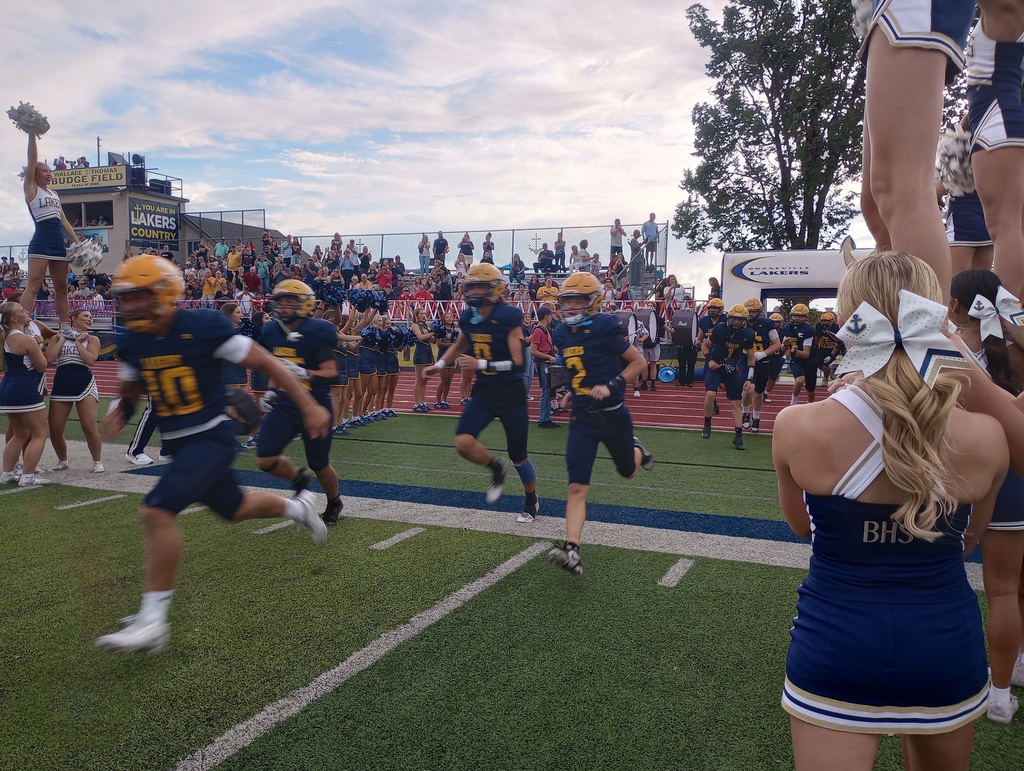 Football players running into the stadium