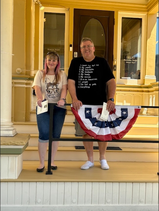 Mrs. Stone and husband in front of historic house