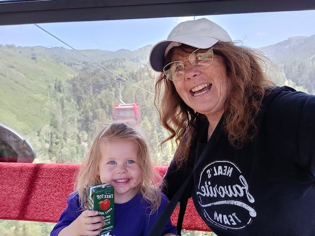 Mrs. Anderson and grand kid on a tram