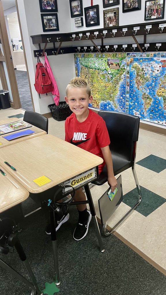 first grader ready for school at desk