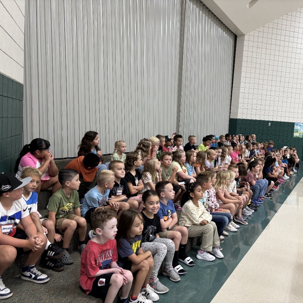 second grade students listening in the cafeteria