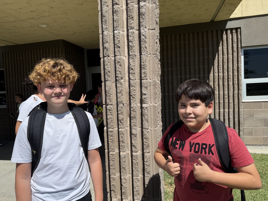two students outside waiting for school