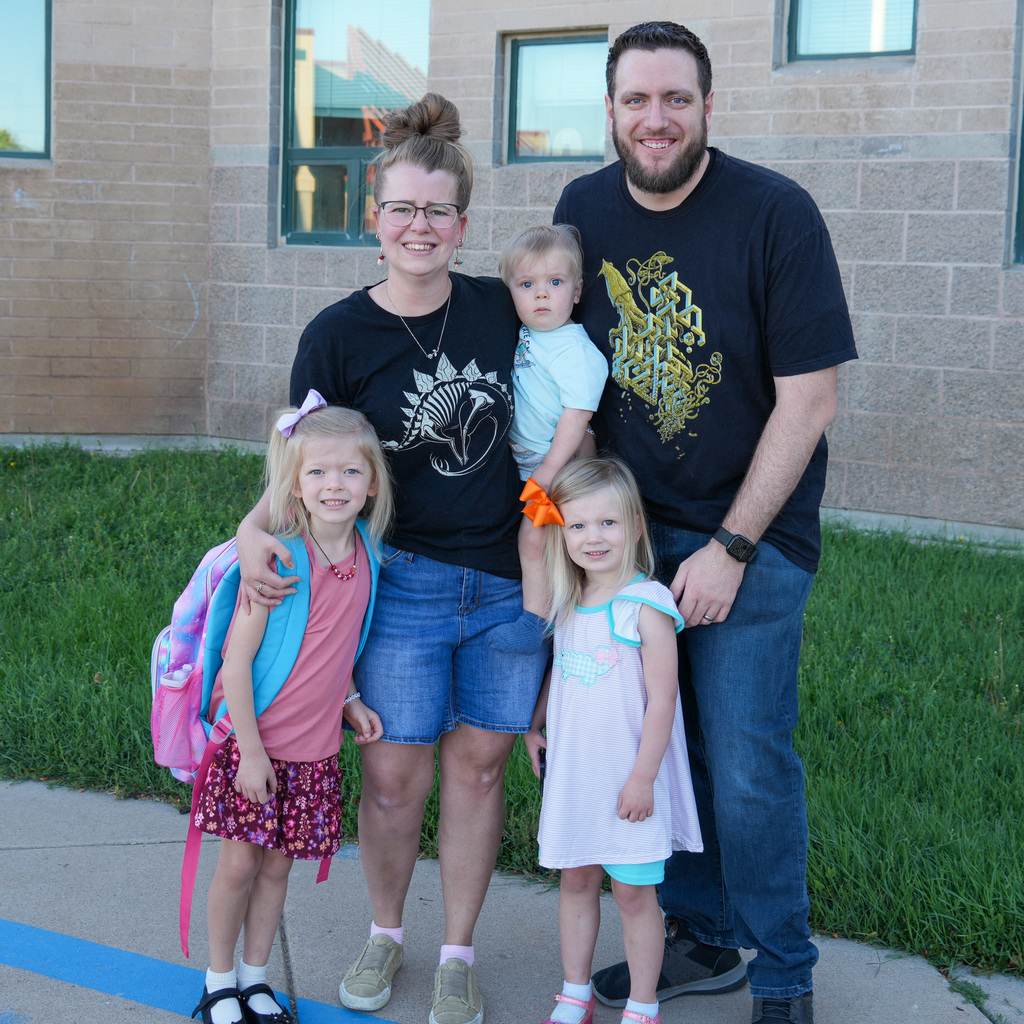 A family dropping off their child to school