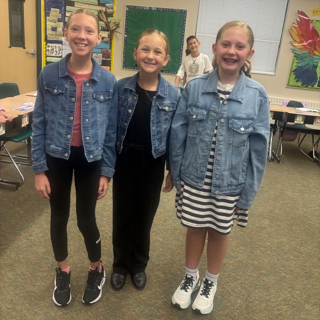 students smiling for the camera in a classroom