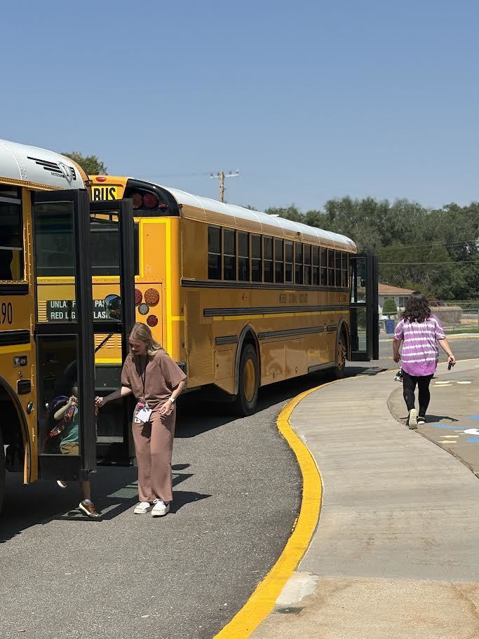 Students getting off buses.