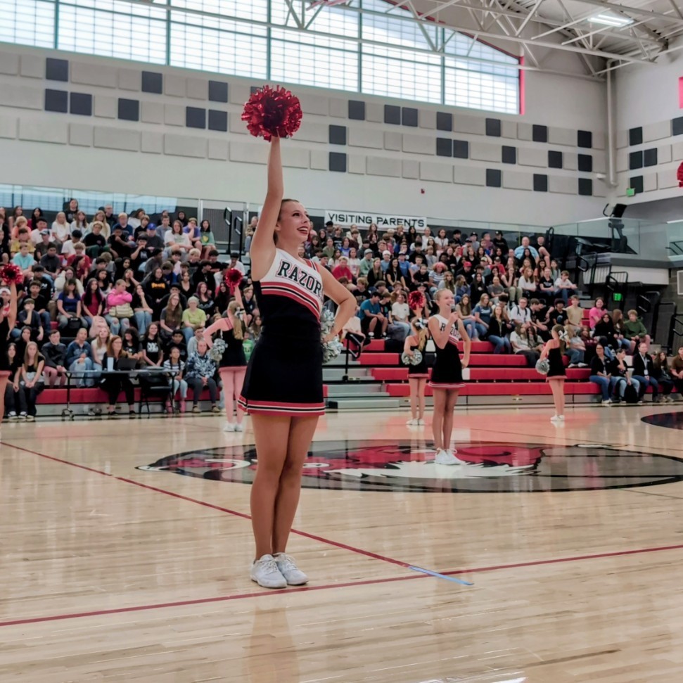 photo of opening assembly at Roy jr high, cheerleaders teaching a cheer to the student body