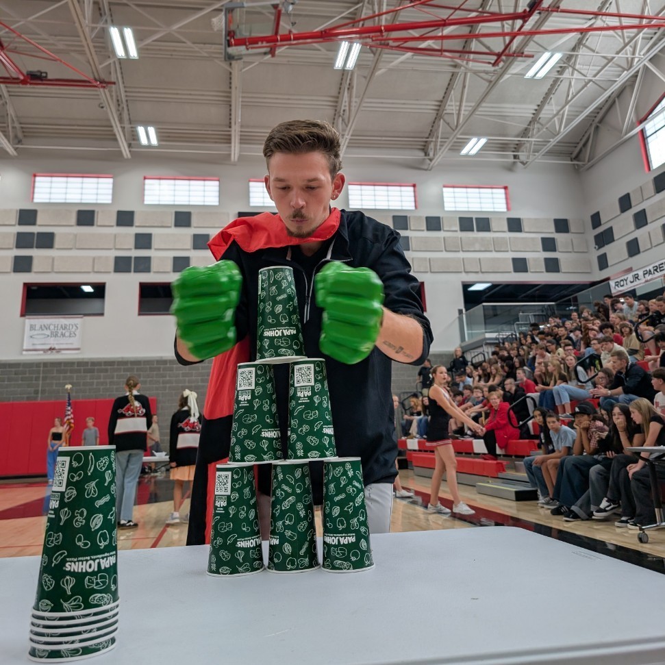 photo of opening assembly at Roy jr high,teacher competing in the relay race