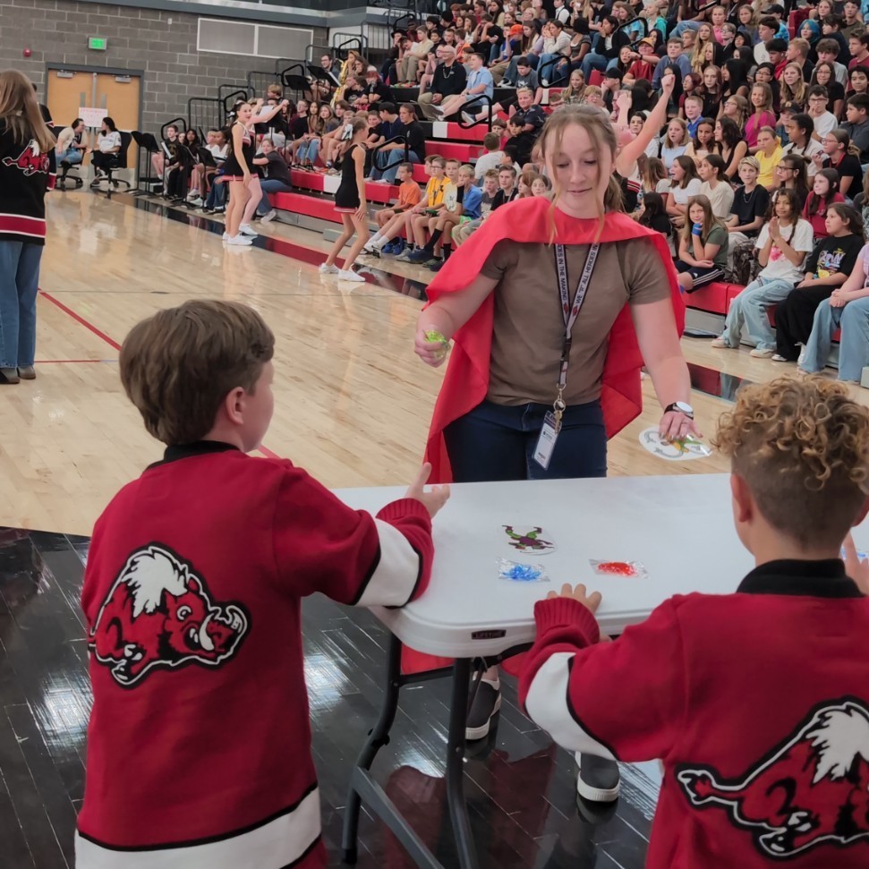 photo of opening assembly at Roy jr high, staff members compete in a relay race