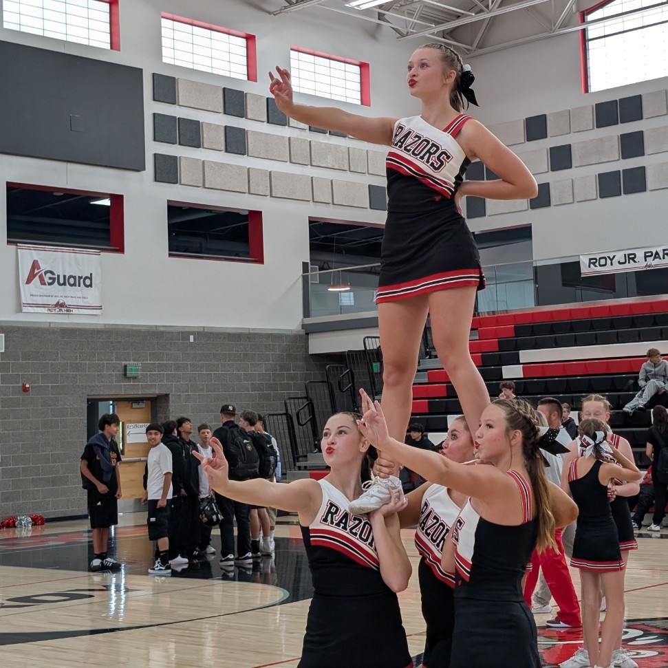photo of opening assembly at Roy jr high, cheerleaders at the end of the assembly