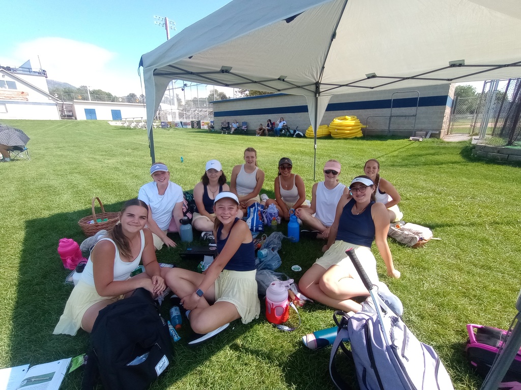 Tennis team cheering on their teammates