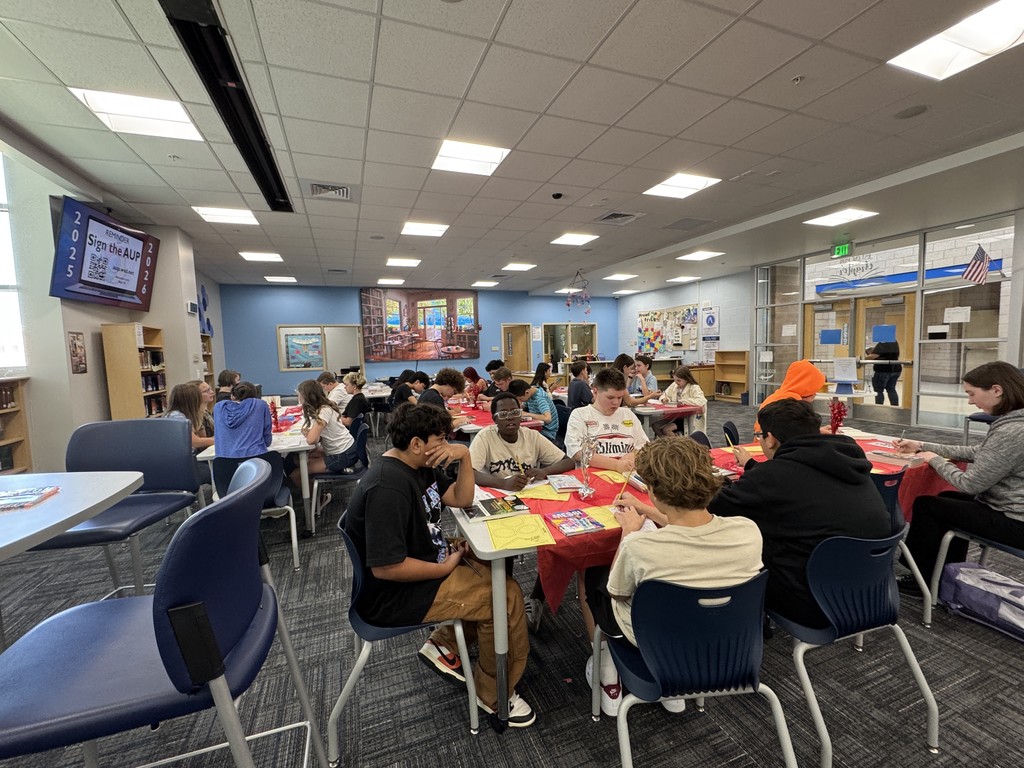 Students looking at books.