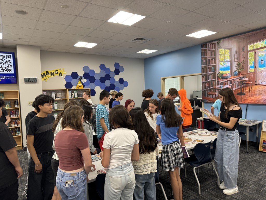 Students looking at books.