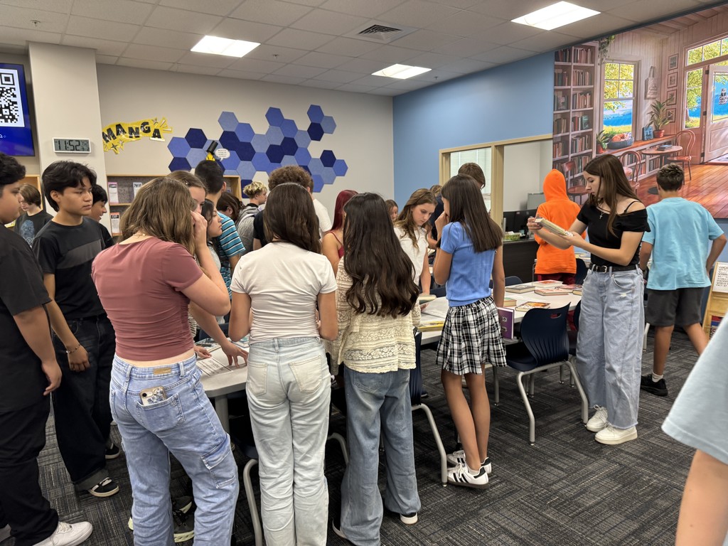 Students looking at books.