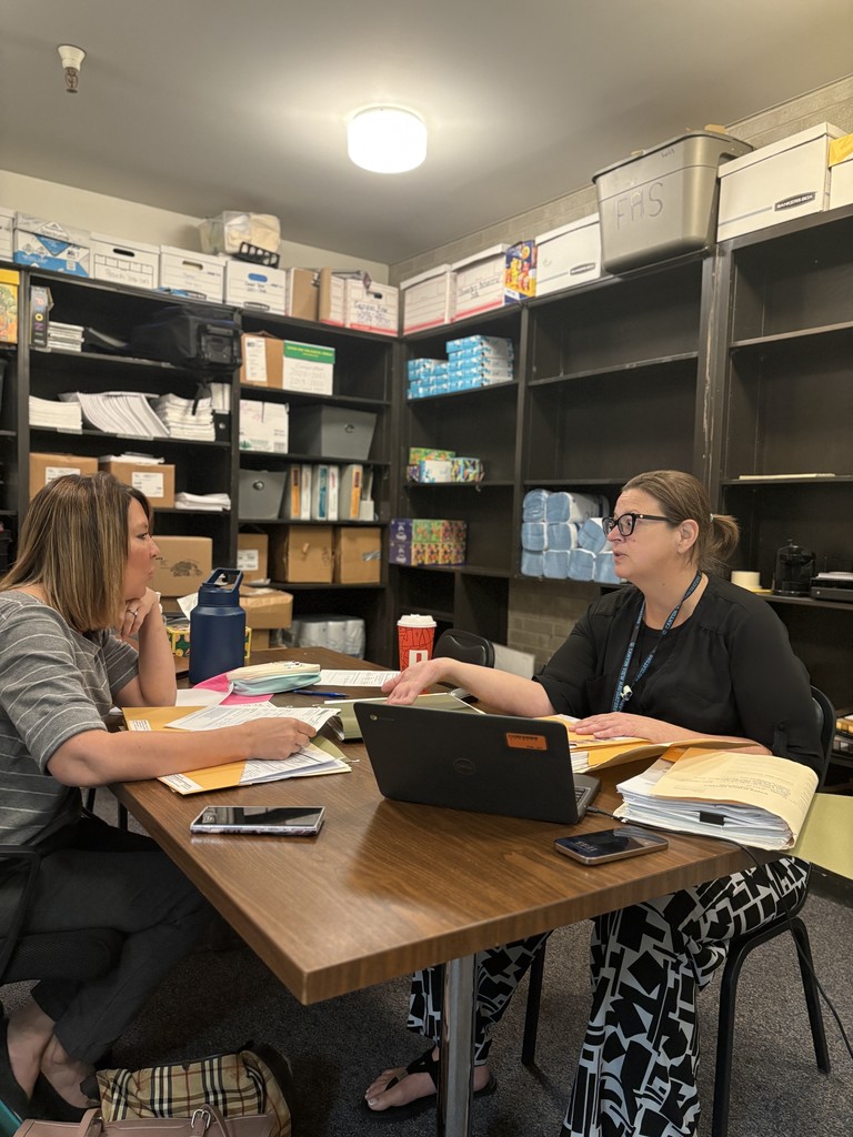 Amber working with another teacher in the  office. 