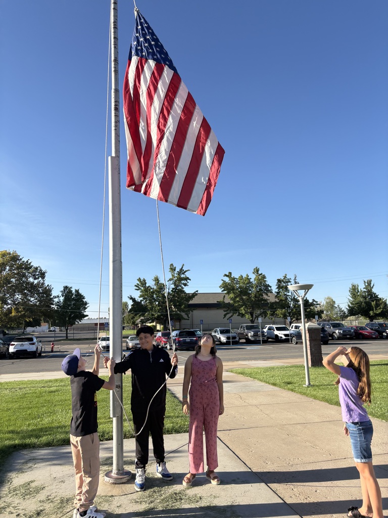 Students hoisting the American Flag