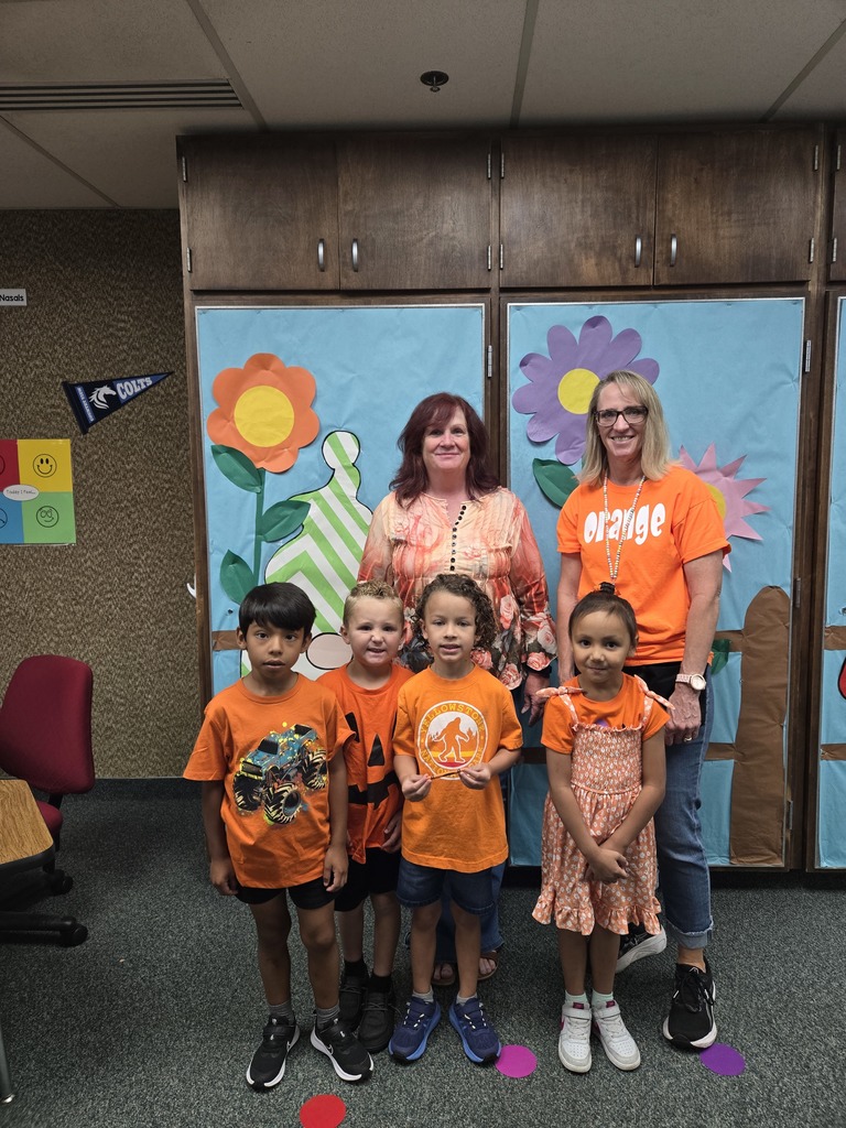 Mrs. Wardle wearing orange supporting Mrs. Perry's class