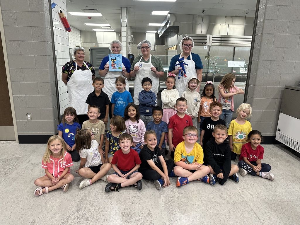 kindergarten students with lunch staff and pete the cat book and stuffed animal