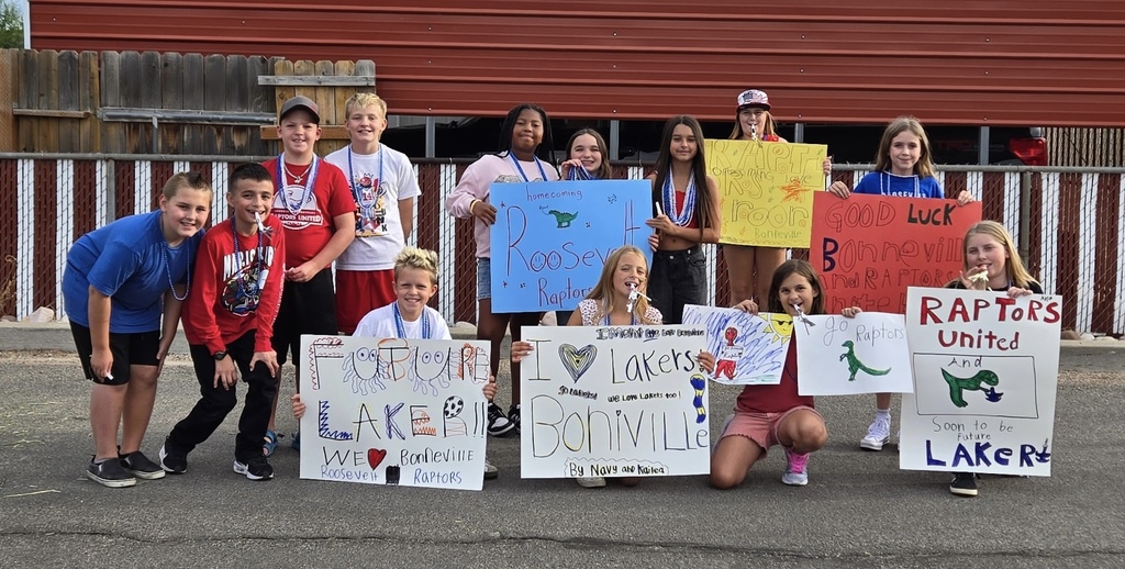 students with their posters showing raptor and laker pride