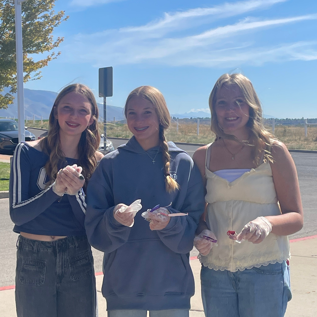 Students from the school's student government walk around the campus, picking up litter during a Day of Service event.