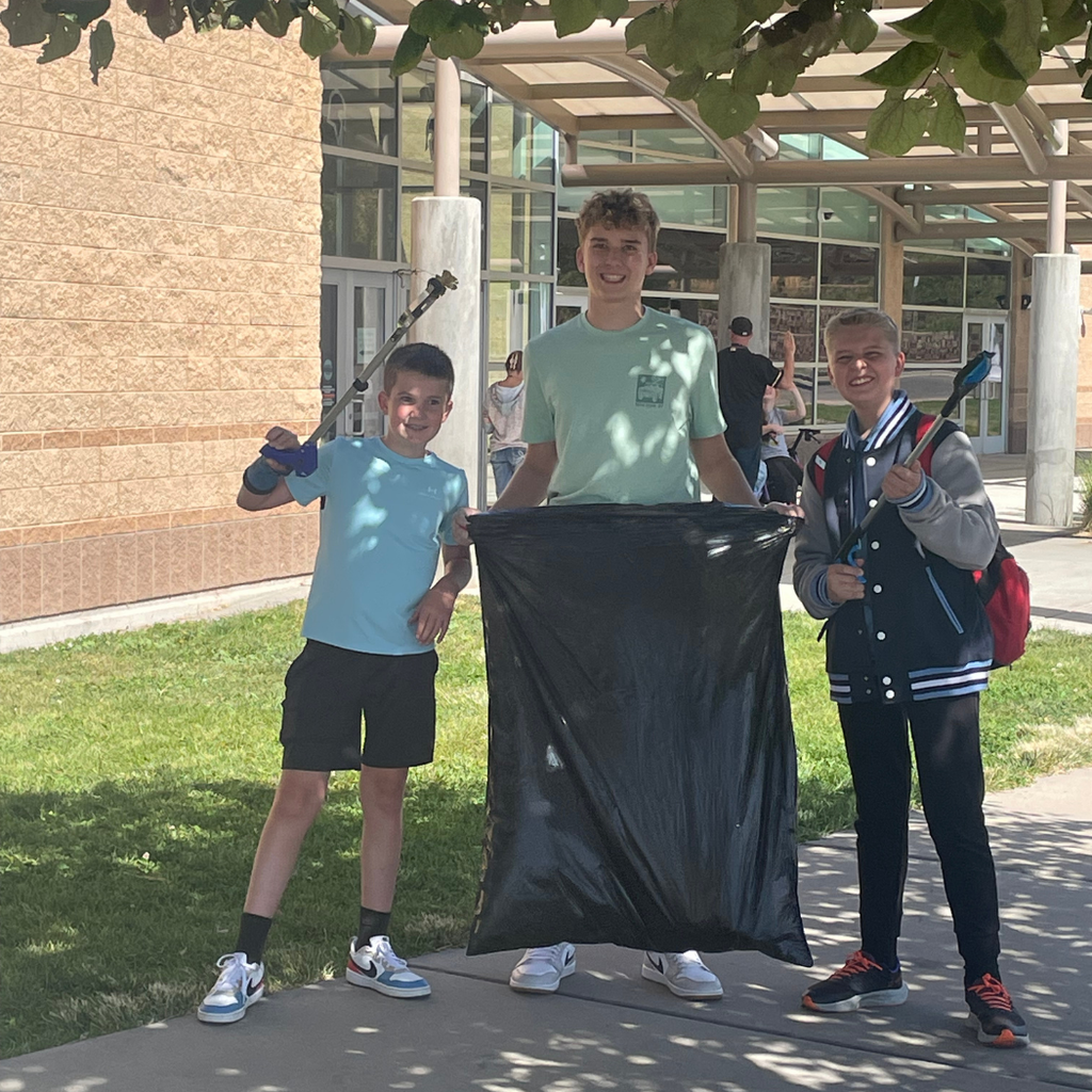 Students from the school's student government walk around the campus, picking up litter during a Day of Service event.