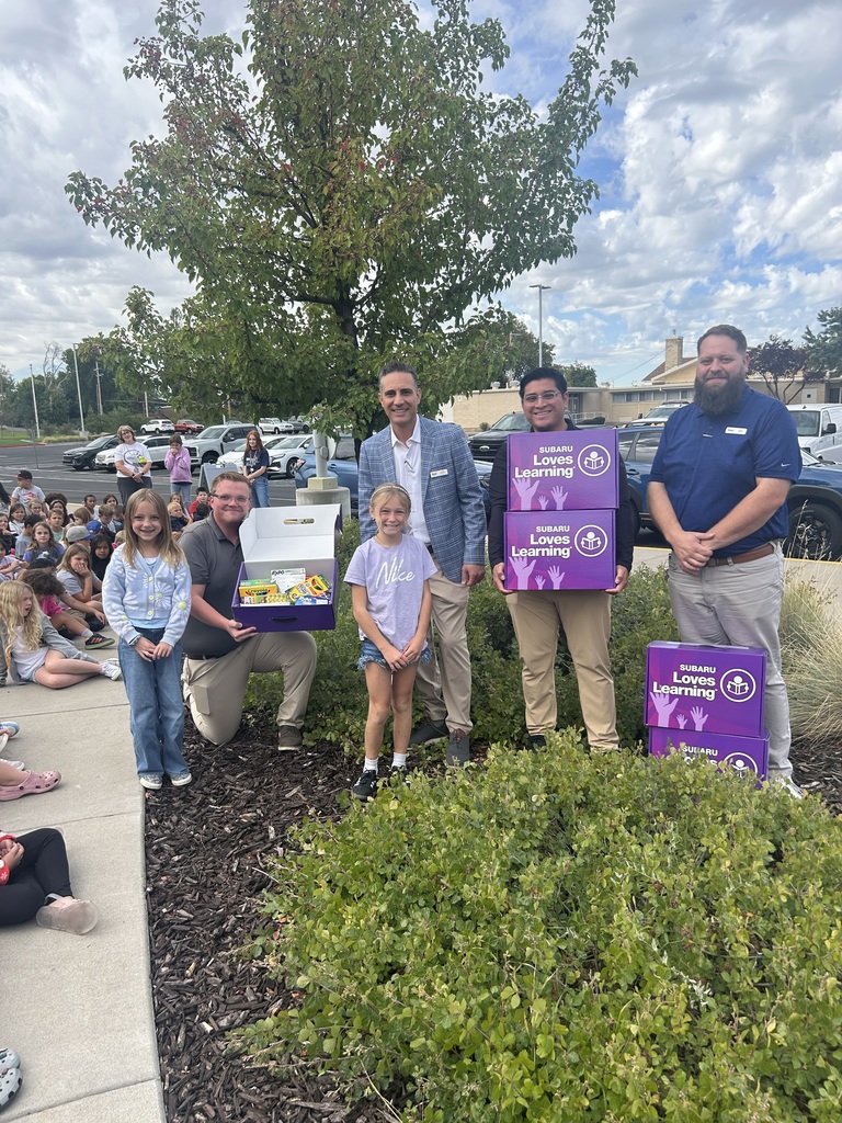 Photo of class donations with students and Young Subaru.
