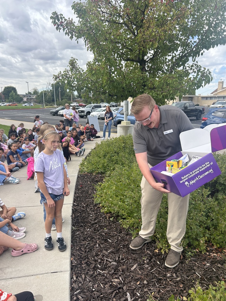 Photo of student receiving donated supplies.