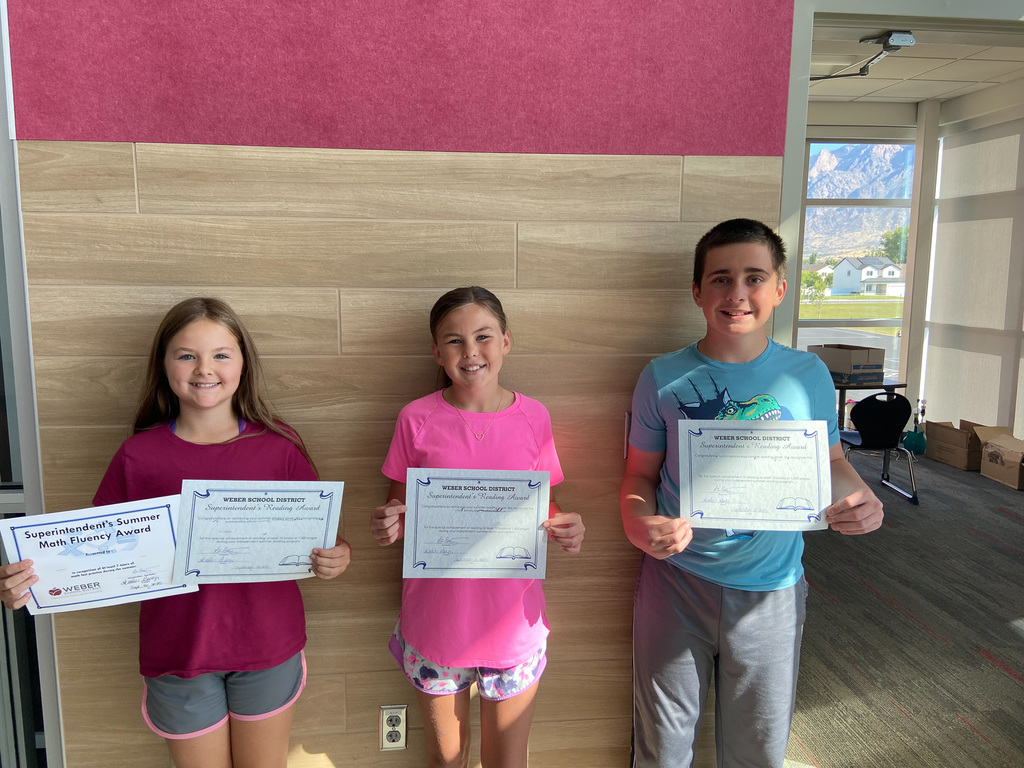 students holding awards