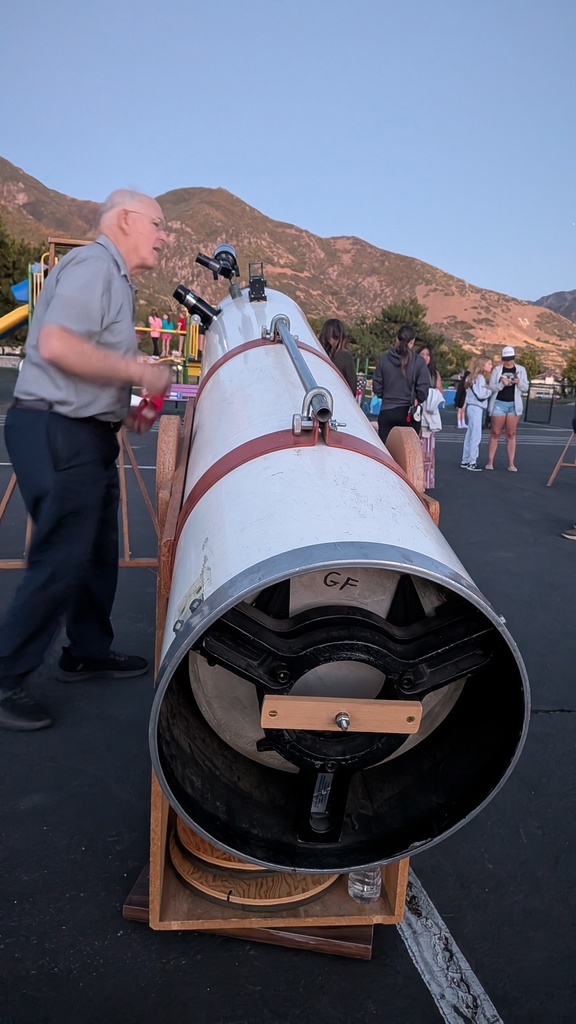 Man with large, homemade telescope