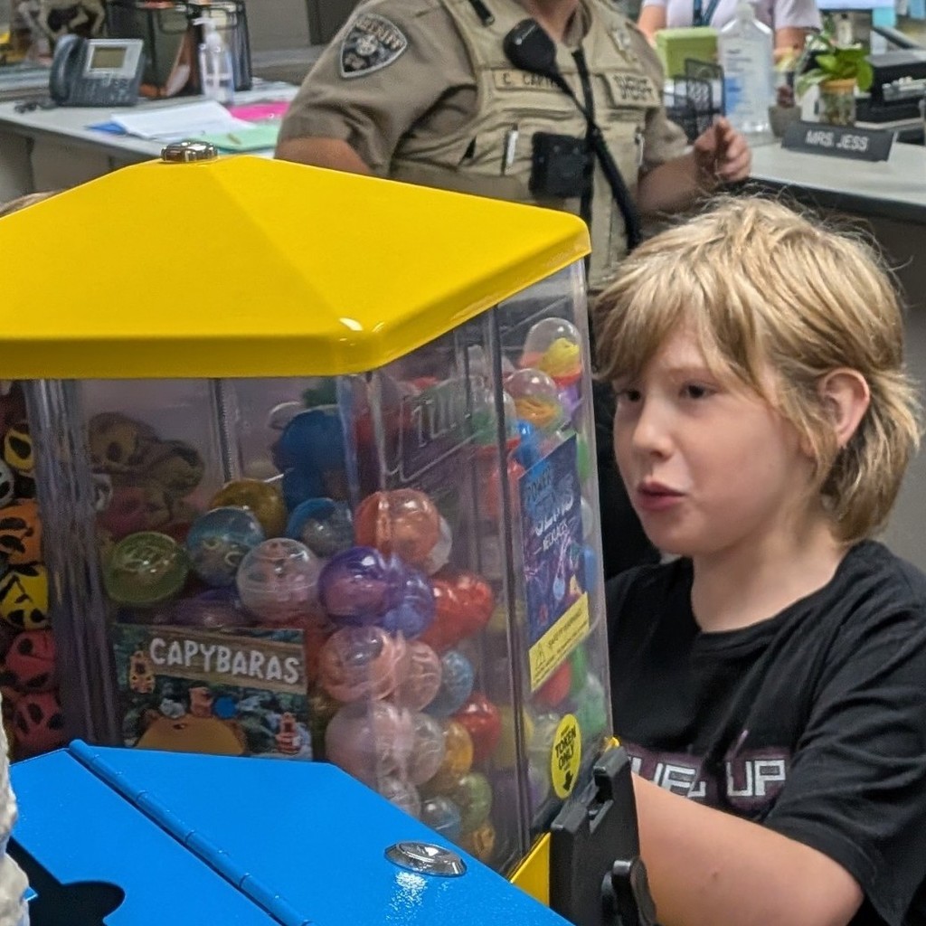 boy getting prize out of vending machine