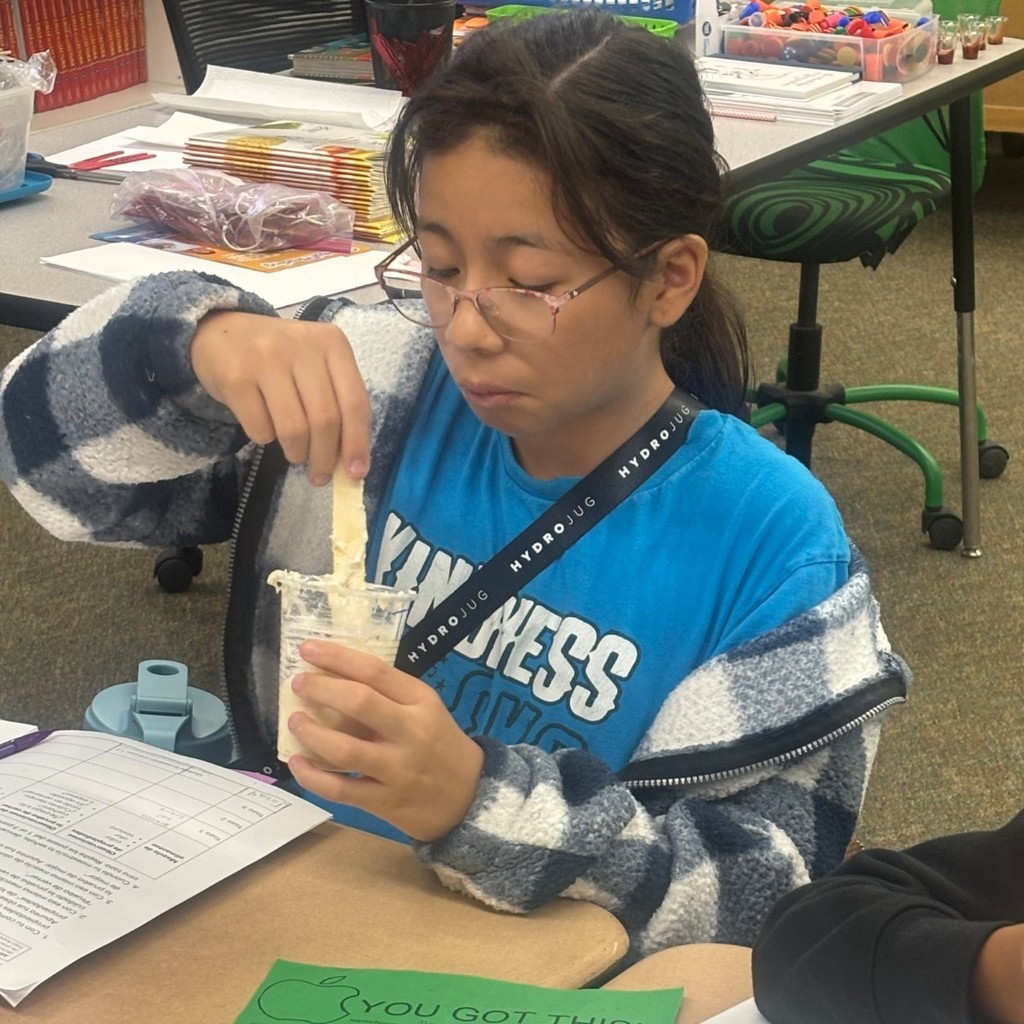 student mixing substances to investigate the properties